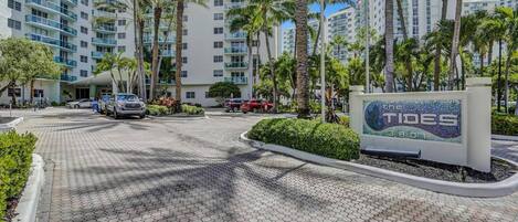 A hotel entrance with a sign reading "The Tides 3801".