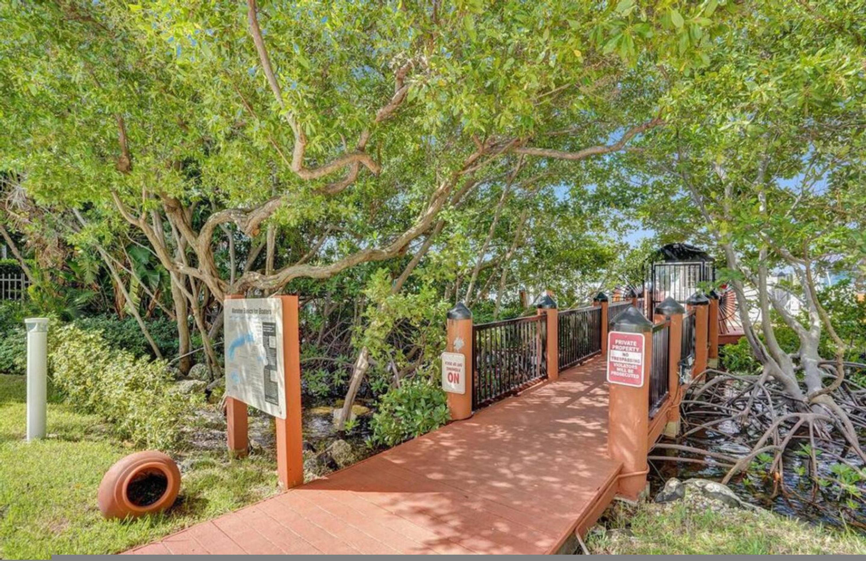 A wooden bridge with a sign indicating private property.