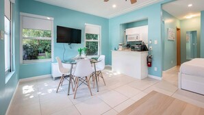 A modern living space with a dining area, kitchen, and a bedroom. - Casa Del Mar Deluxe Studio 2 (Hollywood)