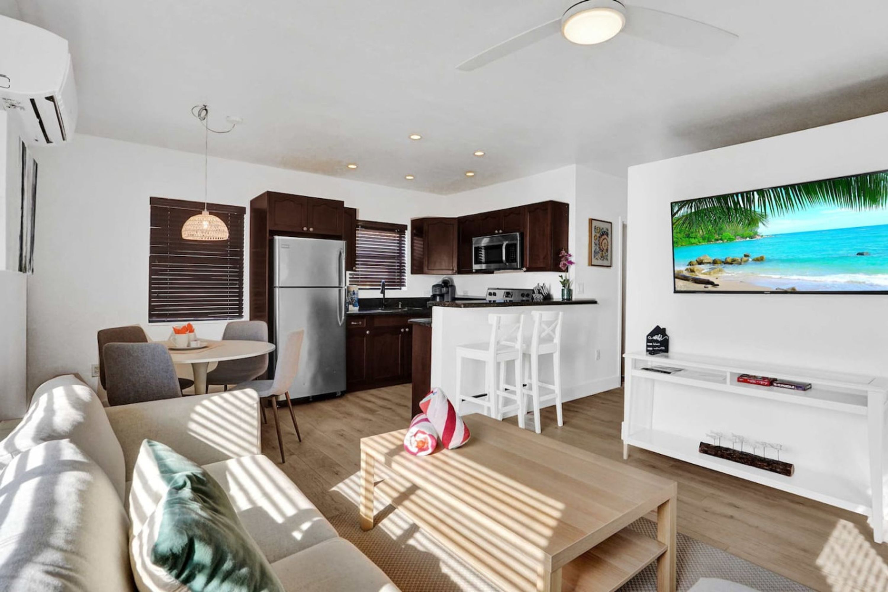 A modern living room with a sofa, a coffee table, and a TV.