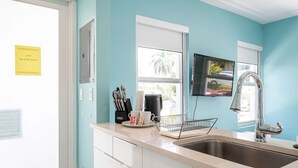 A kitchen with a sink, a coffee maker, and a window with blinds. - Casa Del Mar 4 1 1 Beach Access (Hollywood)