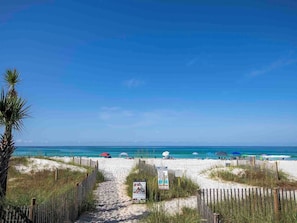 A beach pathway leading to the ocean with a wooden fence on either side. - Horizon South #76G by Resort Collection (Panama City Beach)