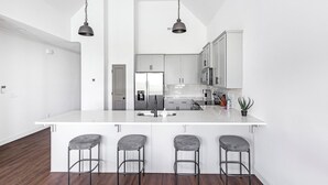 Fridge, dining table - Landing | Chic 2BD, Clubhouse, Gym (Athens)