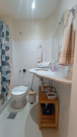 A bathroom with a toilet, sink, and shower area. - Few steps from Ipanema & Arpoador Beaches (Ipanema)