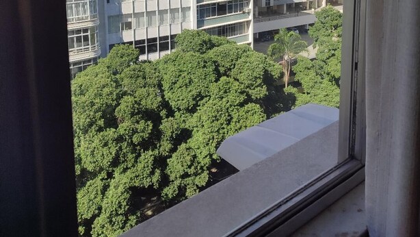A high-rise building with multiple balconies, large windows, and a view of surrounding greenery. - Charming apartment in enjoyable Flamengo Rio de Janeiro near Park Aterro (Flamengo Rio de Janeiro)