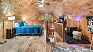 A wooden cabin with a bed, a desk, and a TV. - Mountainside retreat in the Smokies!  6 miles to The Island. Sleeps 8. (Sevierville)