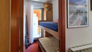 A narrow room with a bunk bed, a radiator, and a framed picture on the wall. - Lodging in Artesina with Alpine view, ski-in/out, fireplace and sleeps 6 (Artesina)