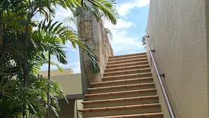 A staircase with terracotta steps leading up to a building. - Yeguas W37 by Wynwood House (Anapoima)