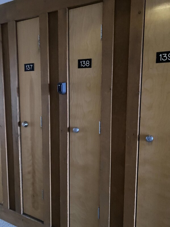 A row of wooden doors with numbers 137, 138, and 139, indicating a hotel or similar accommodation.