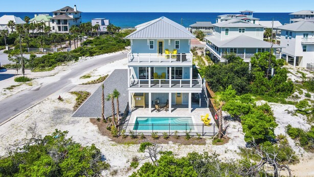 A two-story beachfront house with a pool, multiple balconies, and a view of the ocean. - Little Sunshine (Cape San Blas)