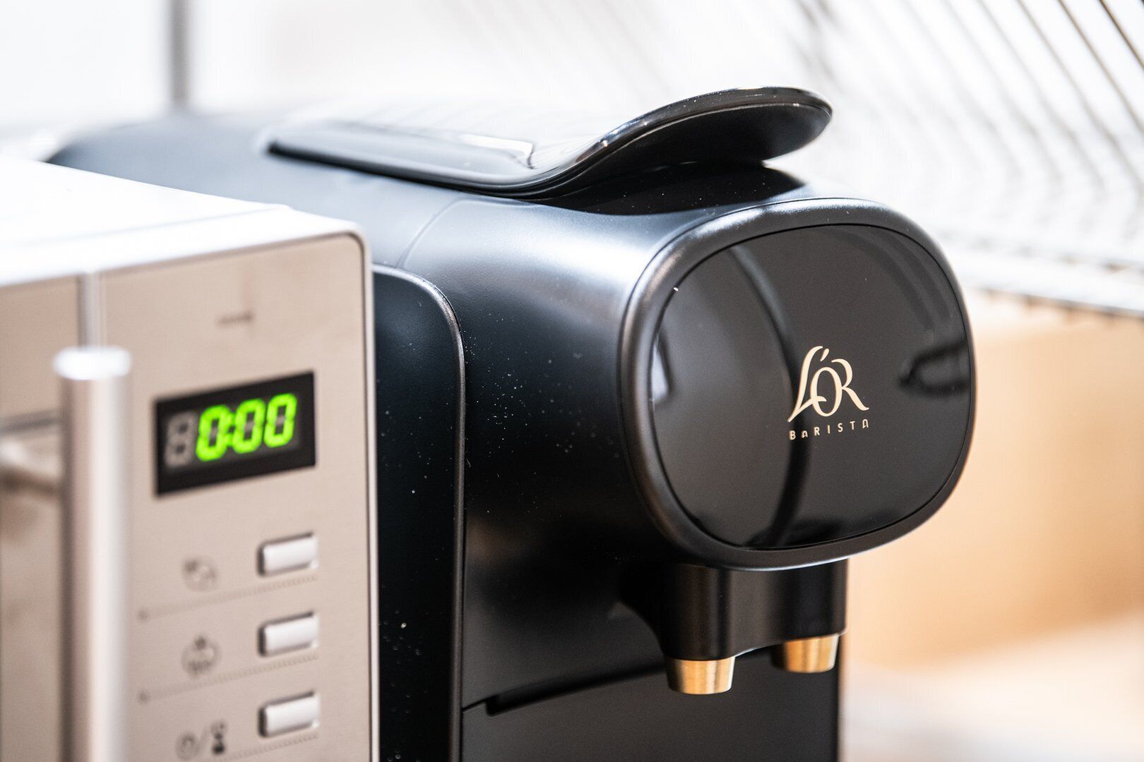 A coffee machine with a digital display and a brand logo.