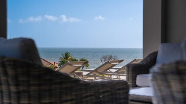 A view from a window overlooking a beach with lounge chairs and a clear sky. - Ocean View 3 bed, 3 bath. Private pool. Steps to the beach in gated community (Peadsi)