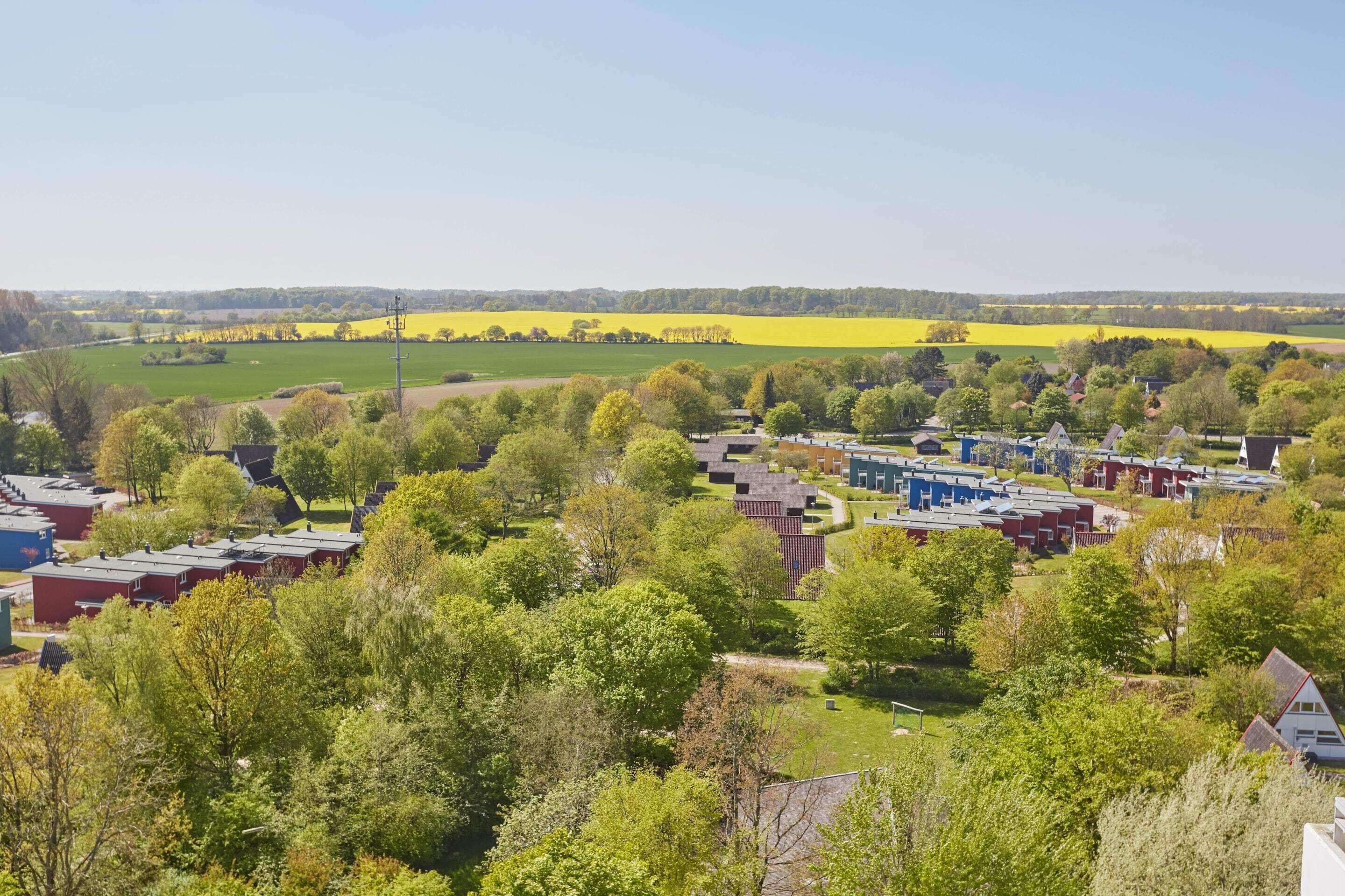 A residential area with houses and a large open field.