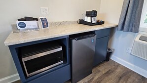 A compact kitchen with a built-in oven, a coffee machine, and a small refrigerator. - Juniper Motel-King Suite Deluxe*RM5*Lakefront*ATV Access (Greenville)