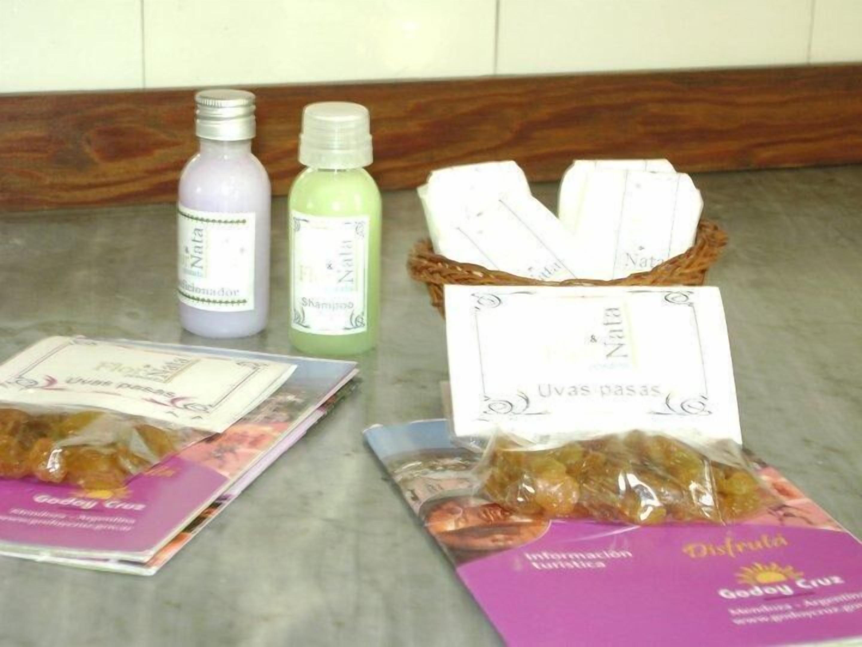 A table with various items including bottles, a basket with cards, and packaged goods.