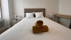 A hotel room with a large bed, two bedside tables, a desk, and a window. - Apartment in Ballon Near Le Mans Circuit (Ballon-Saint-Mars)