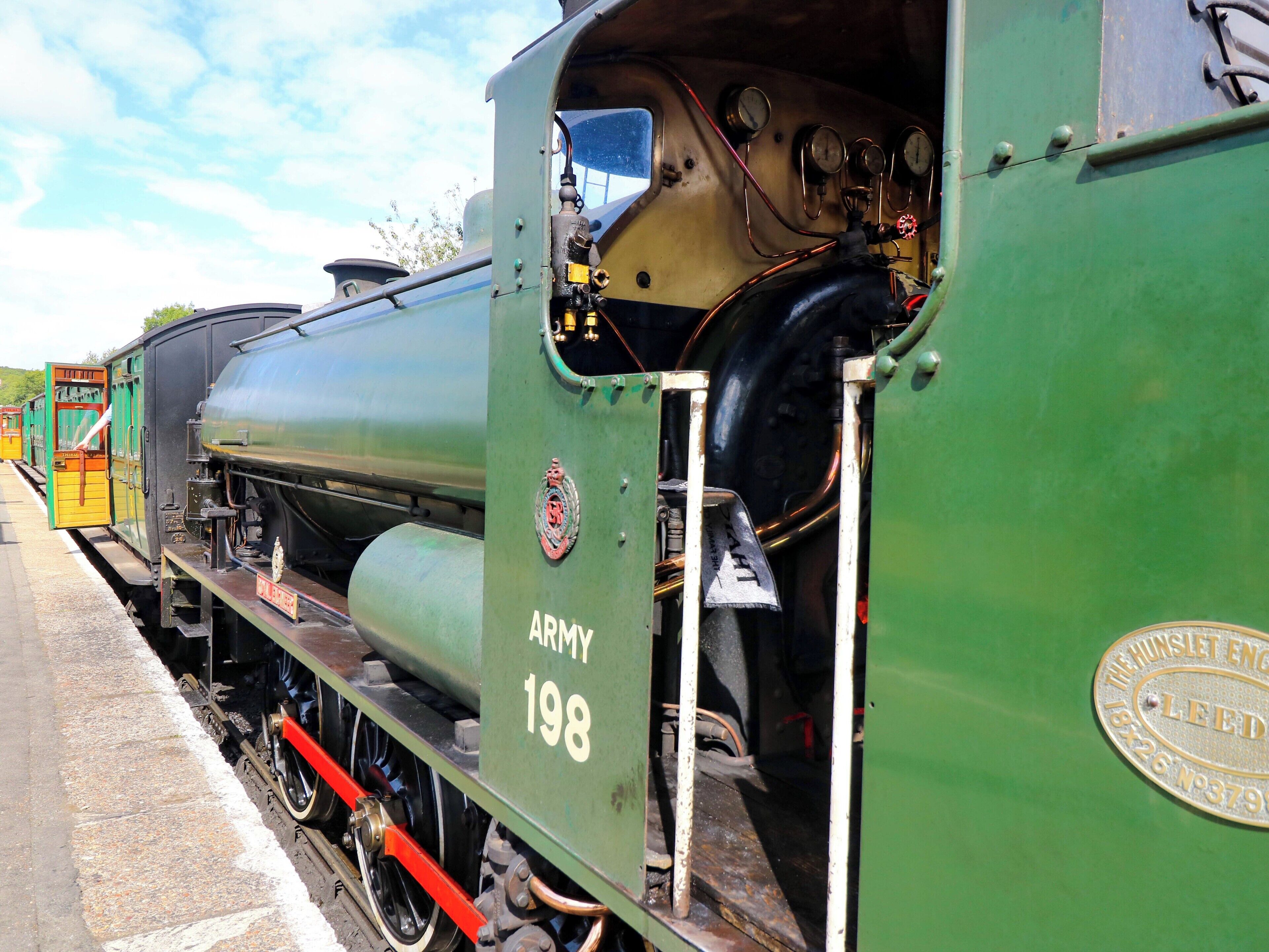 Une locomotive à vapeur verte portant le numéro 198 et le mot « ARMÉE » sur le côté.
