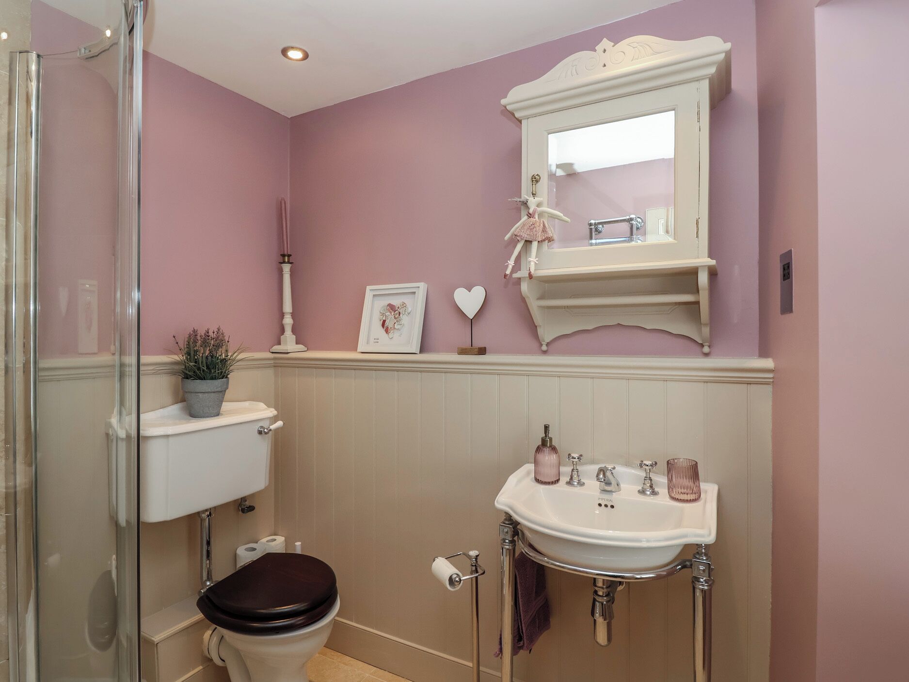 A bathroom with a toilet, sink, and shower.