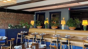 A restaurant with a brick wall, wooden seating, and potted plants. - SGV+Disney+Rose Bowl•King Studio near DTLA (Alhambra)