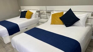 Two single beds with white and blue bedding, a white headboard, and bedside tables with lamps. - SGV Quadruple Room + Explore Disney & Downtown LA (Alhambra)
