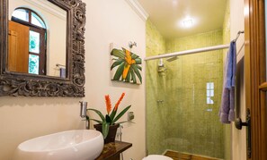 A bathroom with a white sink, a mirror with an ornate frame, a potted plant, and a shower with a bamboo curtain. - The Coral Penthouse - 4 Bedrooms (Rio de Janeiro)