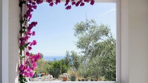 A window with a view of a garden and the sea. - ADRIANA'S House KARDAMYLI PROSILIO (Unknown)
