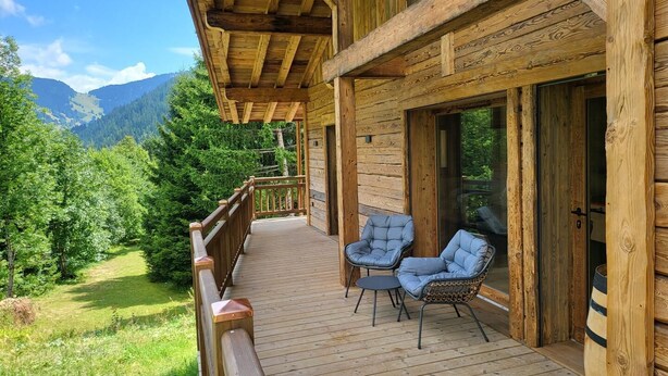 A wooden cabin with a balcony overlooking a forested valley and mountains. - CHALET DES FEES - BEAUFORT (BEAUFORT)