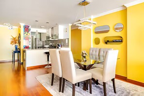 A modern kitchen with white cabinets and stainless steel appliances. - Stylish Miraflores Apt • Walk to Sea • WiFi • Optional AC • Parking (Miraflores)
