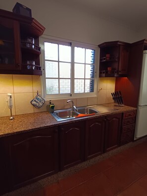 A kitchen with a window, a sink, cabinets, and a countertop. - Dotty's House (Santa cruz)
