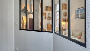 Una habitación con un ventanal grande, estanterías de madera y un sofá.