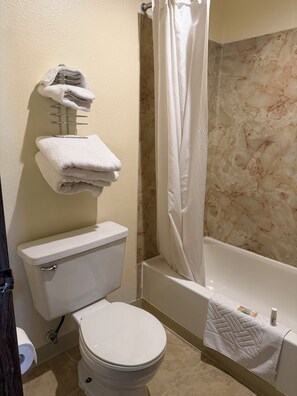 Combined shower/bathtub, towels, soap, toilet paper