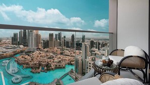 A balcony with a city view, including high-rise buildings and a marina.