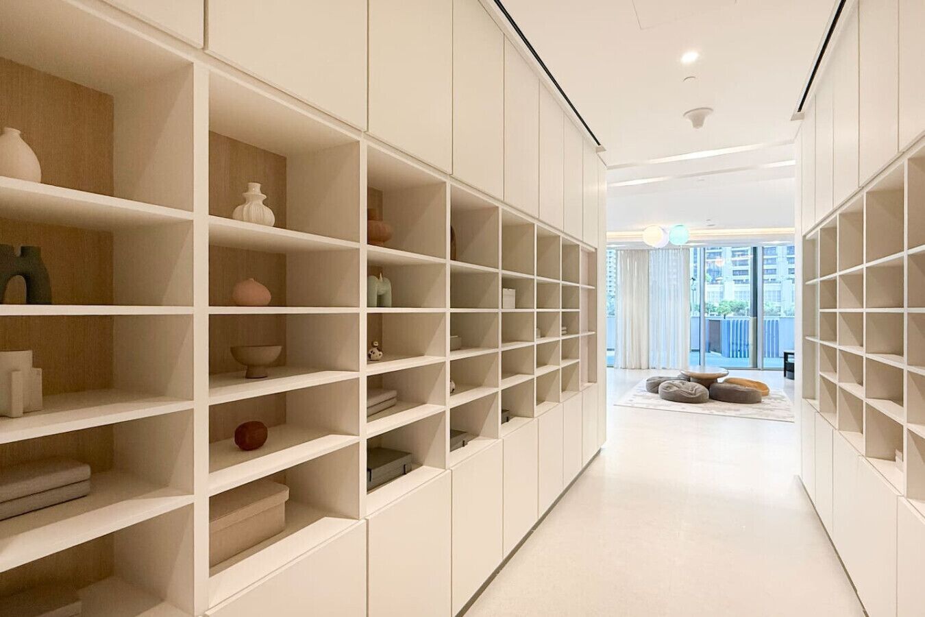 A modern, minimalist interior with white shelving units and a clean, bright design.
