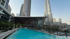 A swimming pool with a modern building in the background.
