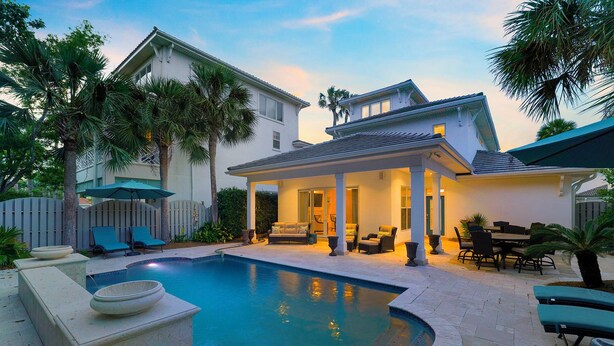 A poolside area with a covered patio, outdoor furniture, and a pool. - Tropical Dreams by the Sea - Vacation Home with Private Pool & Close Proximity to Beach (Destin)