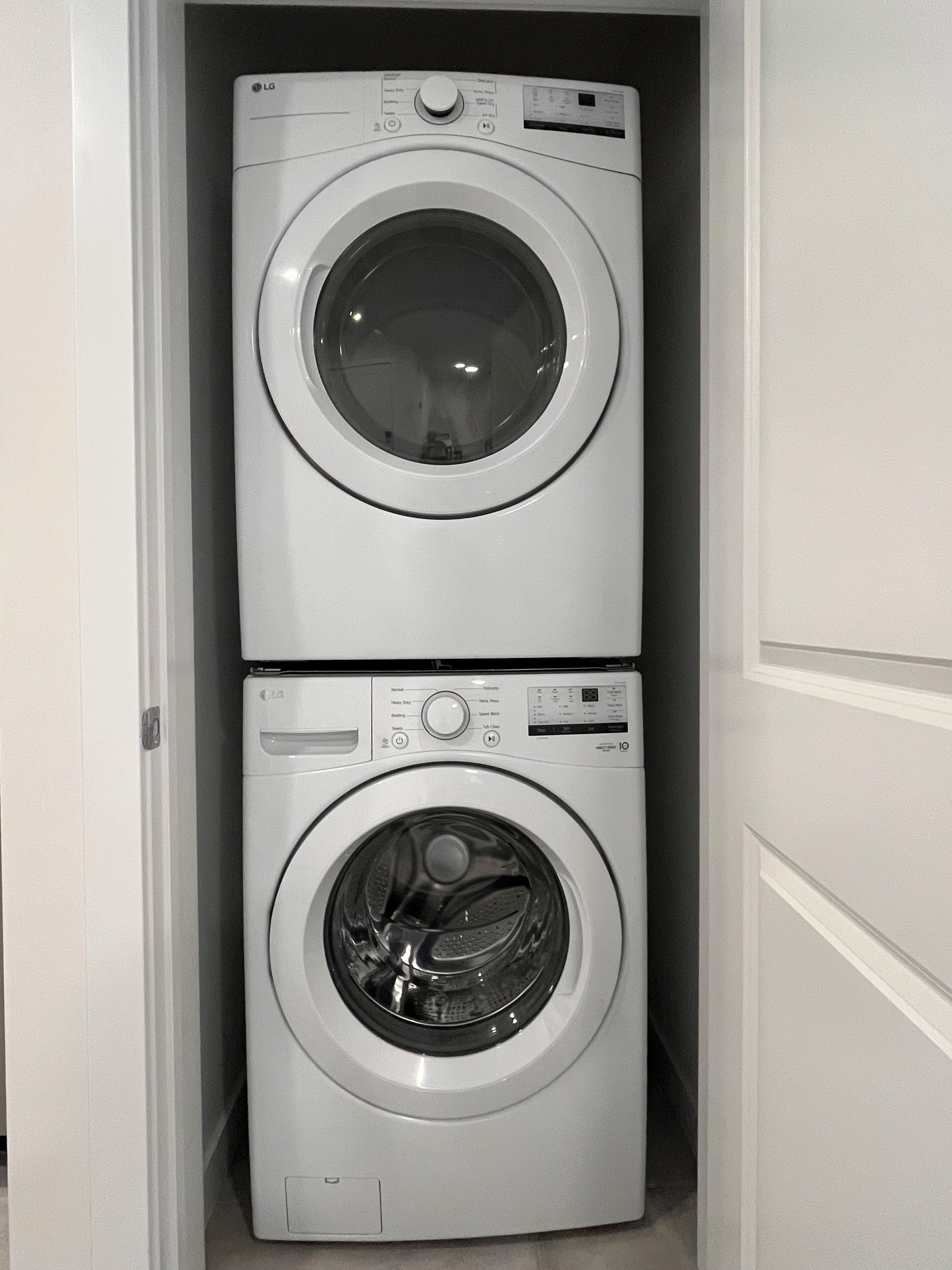 A compact laundry room with two stacked washing machines.
