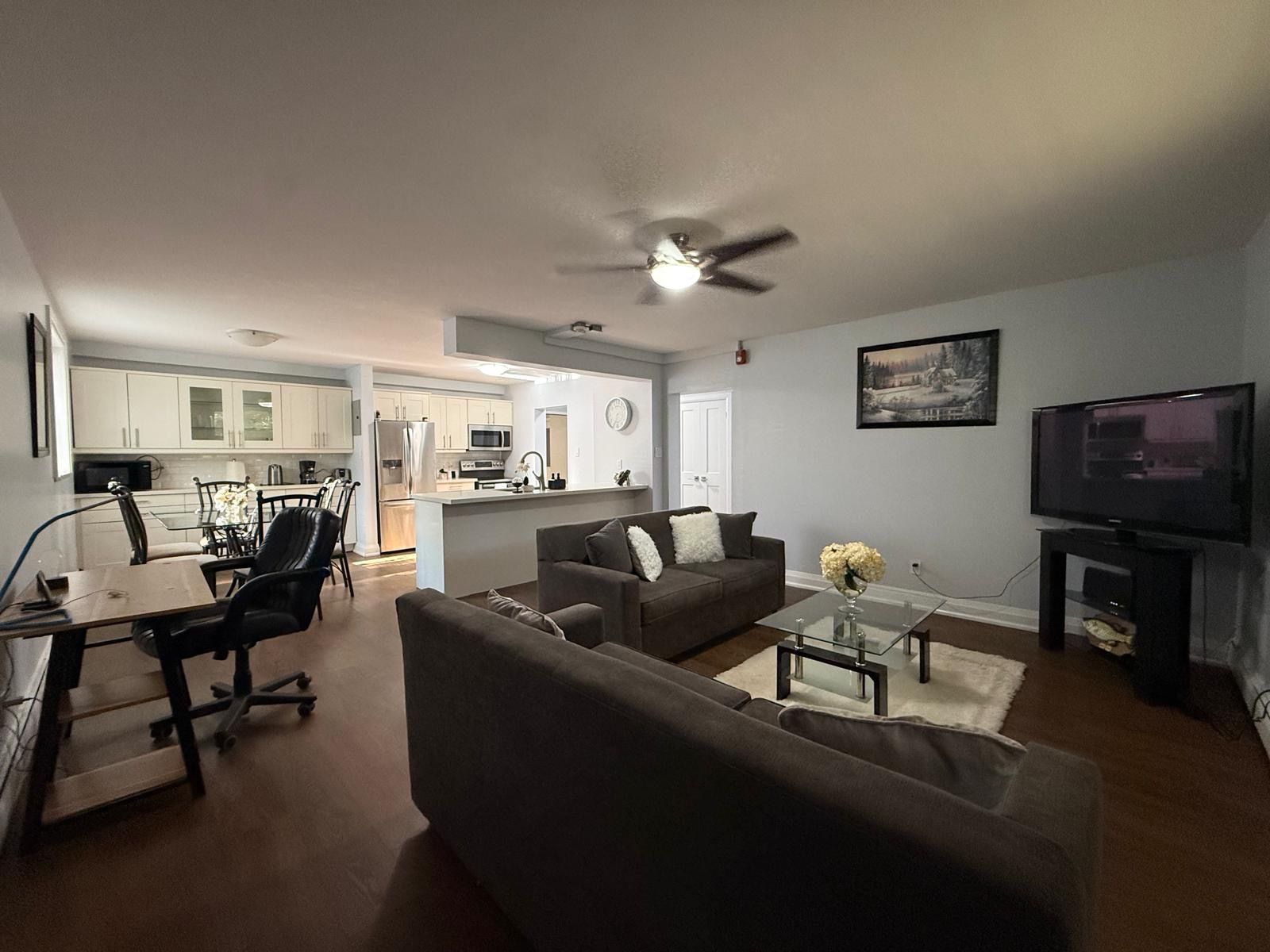 A modern living room with a sofa, coffee table, and a television.