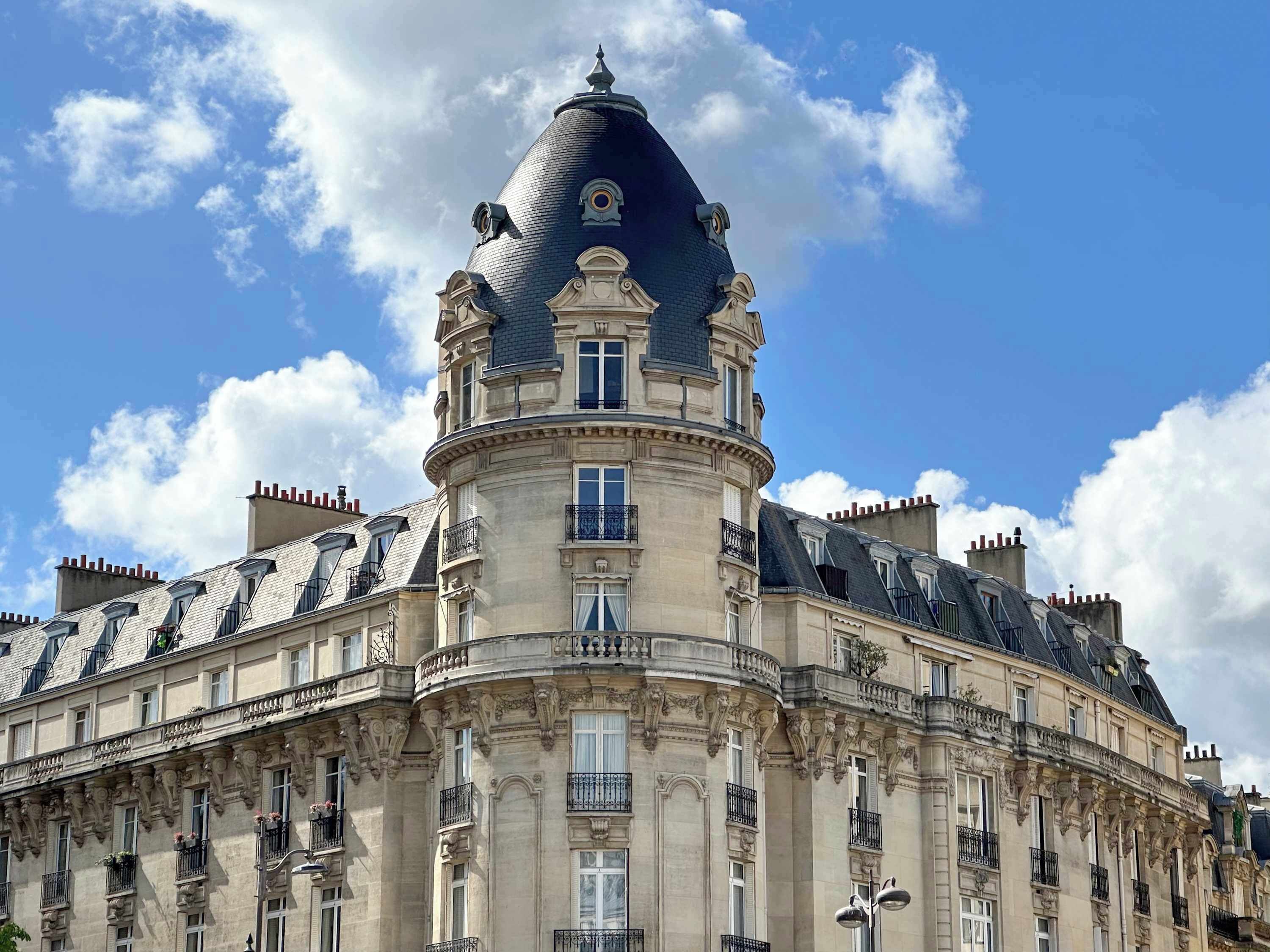 A historic building with a prominent dome and ornate balconies.