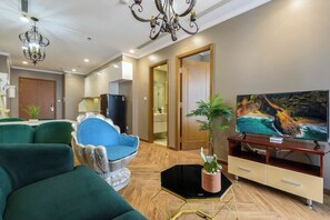 Deluxe Apartment, 1 Bedroom, Balcony, City View | Living area | 32-inch Smart TV with cable channels, pay movies, offices