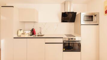 Comfort Apartment, City View | Private kitchen | Fridge, microwave, oven, stovetop