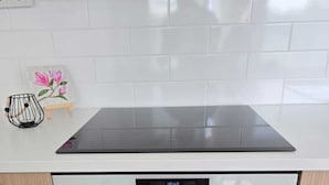 A kitchen with a built-in oven and a stovetop. - Metsämansikan helmi I Free parking, WiFi and Netflix (Espoo)