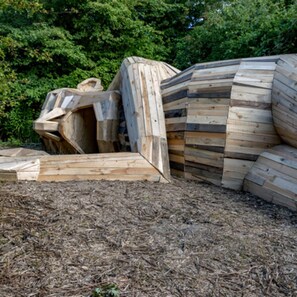 A structure made of stacked wooden planks, surrounded by a natural, wooded area. - Entire home in Rødovre Denmark (Rødovre)