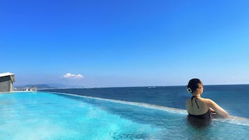 Outdoor pool, open 6:00 AM to 10:00 PM, pool umbrellas