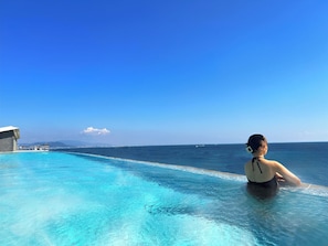 Outdoor pool, open 6:00 AM to 10:00 PM, pool umbrellas