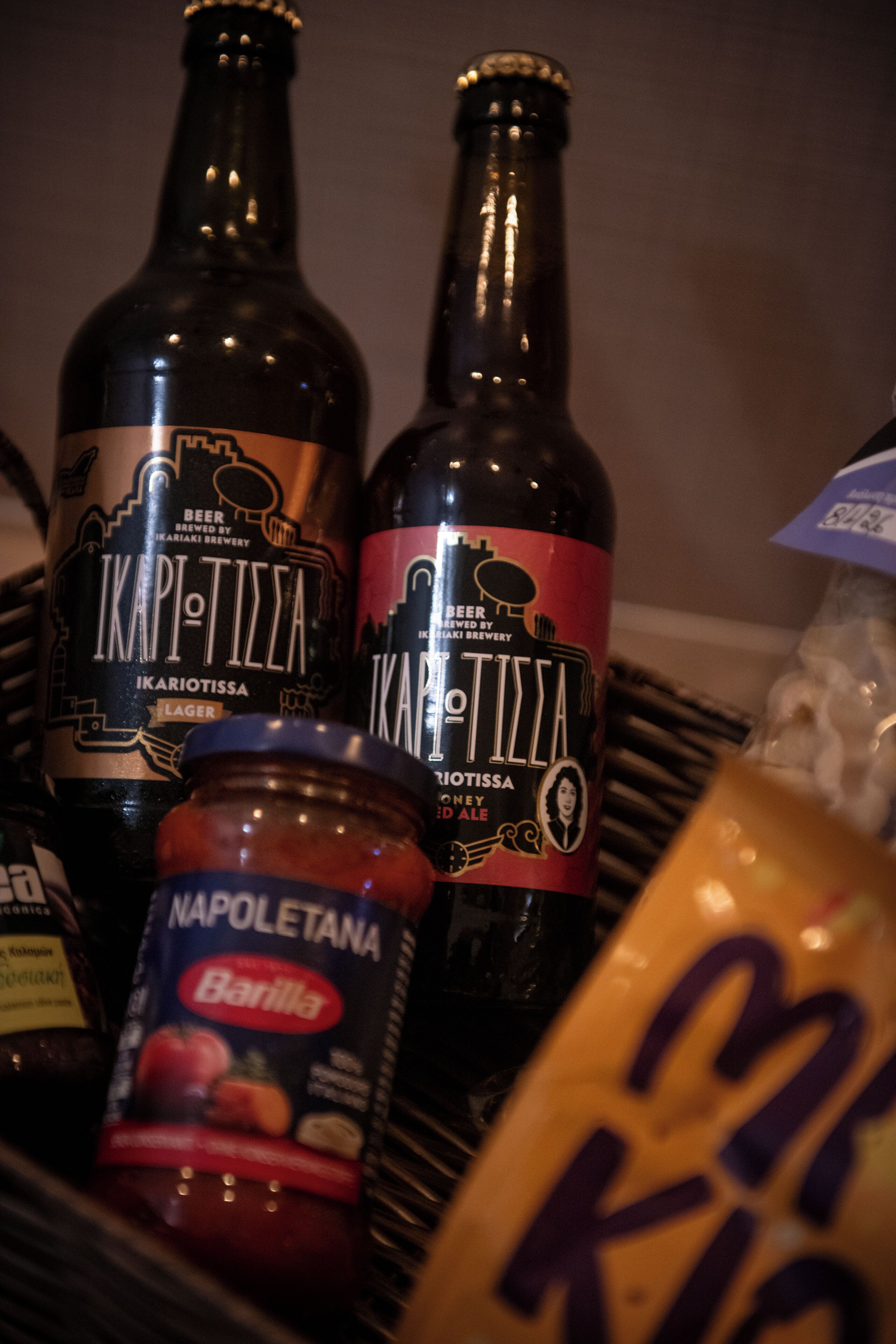 A selection of beverages including two bottles labeled 'Ikapi-Tilla' and a jar of 'Barilla'.