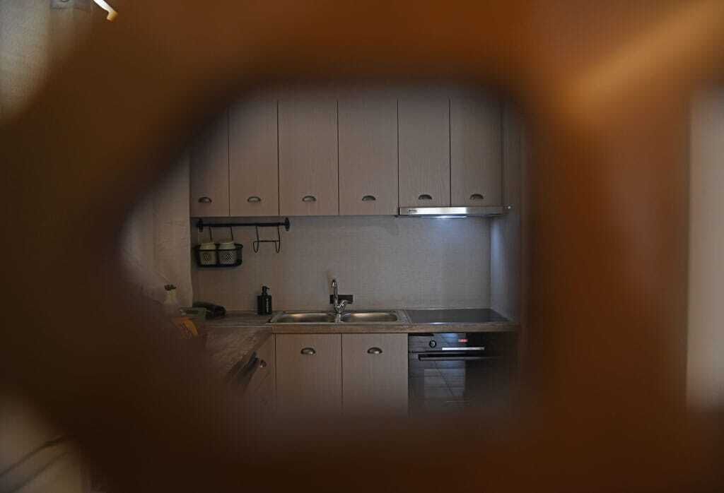 A kitchen with cabinets, a sink, and a dishwasher.