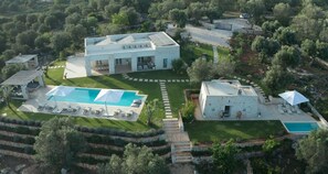 A modern villa with a swimming pool, outdoor seating, and a stone pathway. - Villa in Ostuni with 10 bedrooms sleeps 24 (Ostuni)