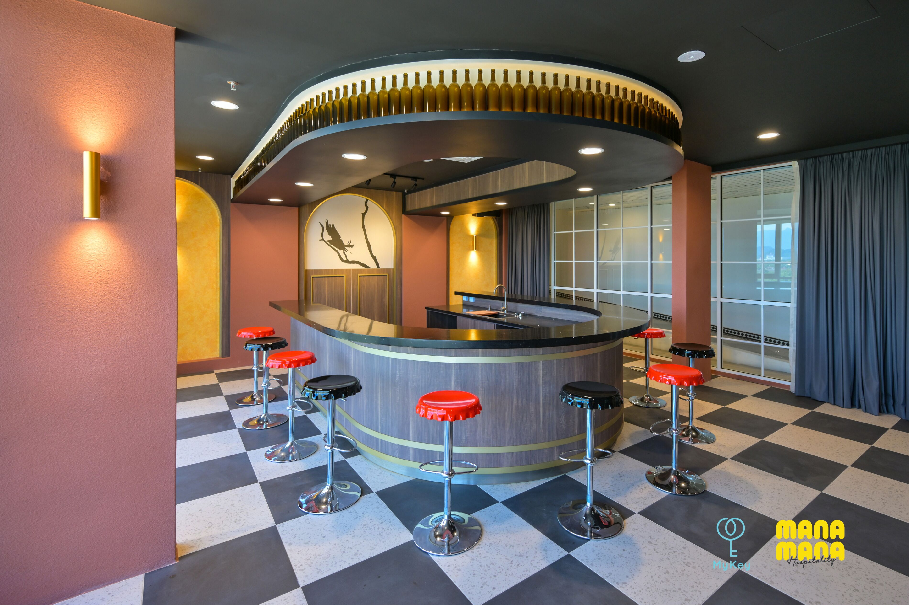 A bar area with a checkered floor, a curved counter, and red bar stools.