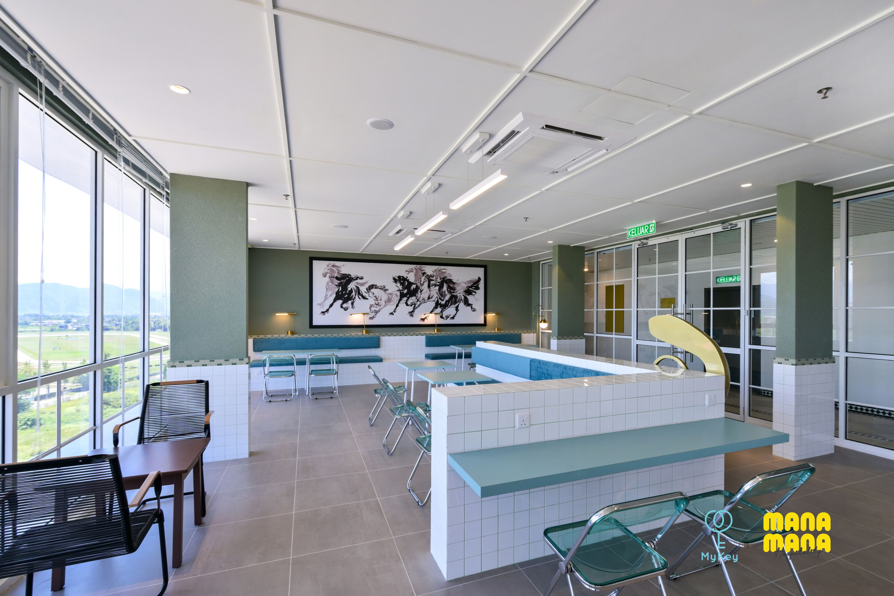 A modern indoor area with seating, a reception desk, and a large window offering a view.
