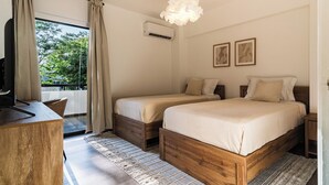 A bedroom with two beds, a desk, and a large window with curtains. - City Center Modern Boho Stay (Nicosia)